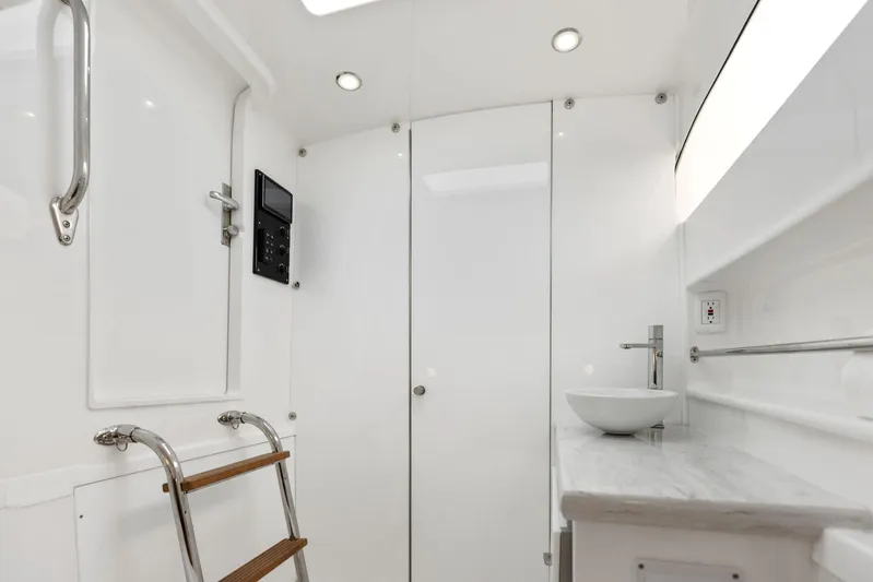  Yacht Photos Pics 2025 Mag Bay 43 CC boat interior with modern bathroom and wooden ladder.