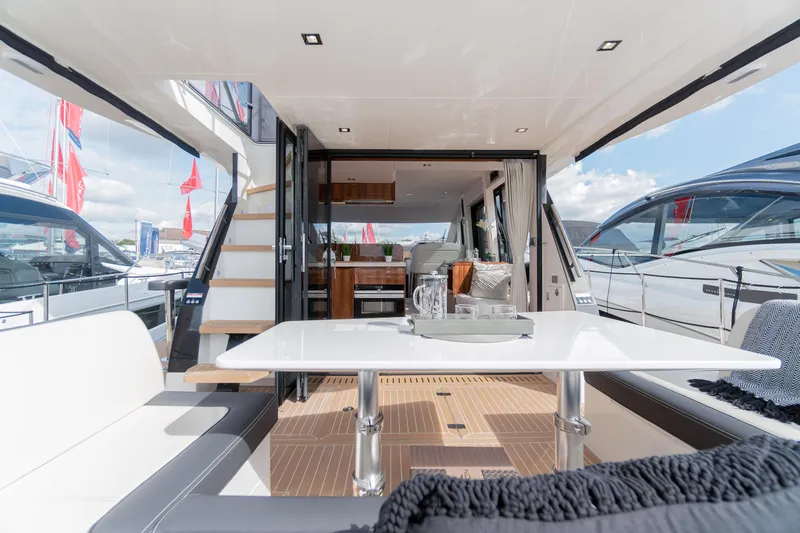 Allouise Yacht Photos Pics Luxurious interior of 2022 Galeon 460 Fly yacht with modern seating and dining area.