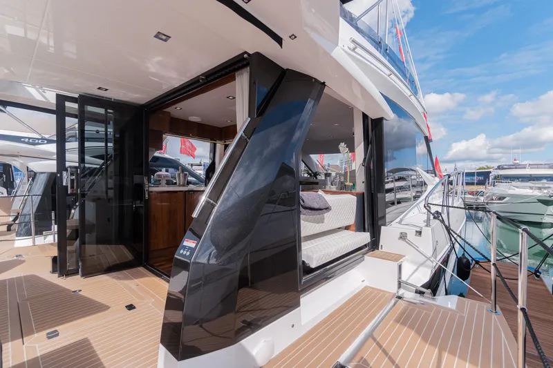 Allouise Yacht Photos Pics 2022 Galeon 460 Fly yacht with open deck and luxurious interior at a marina.