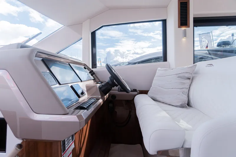 Alouise Yacht Photos Pics Interior of 2022 Galeon 460 Fly yacht, featuring modern helm and plush seating.