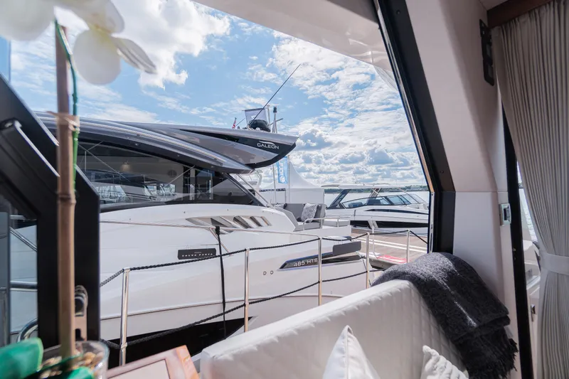 Allouise Yacht Photos Pics 2022 Galeon 460 Fly yacht docked, viewed from interior with blue sky and clouds.