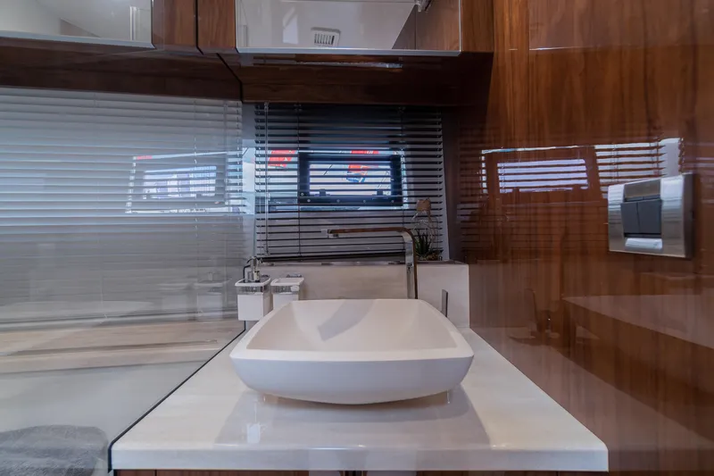 Allouise Yacht Photos Pics Luxurious bathroom interior on 2022 Galeon 460 Fly yacht, featuring modern sink and sleek wood finishes.