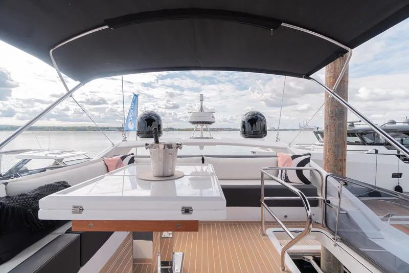 Allouise Yacht Photos Pics Luxurious 2022 Galeon 460 Fly yacht deck with seating and table, under a canopy.