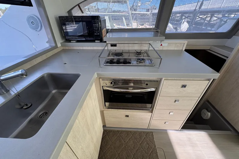 Daylight Yacht Photos Pics Modern kitchen in a 2018 Leopard 40 catamaran with stove, oven, and sink.