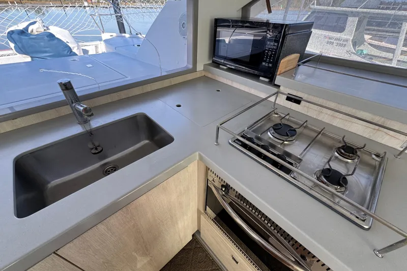 Daylight Yacht Photos Pics Modern kitchen in 2018 Leopard 40 yacht with stove, sink, and microwave.