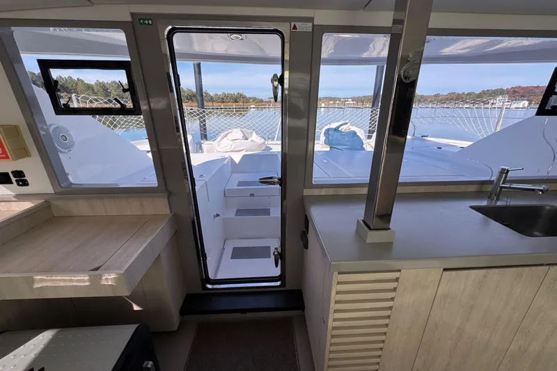 Daylight Yacht Photos Pics Interior view of 2018 Leopard 40 catamaran, featuring modern kitchen and outdoor access.