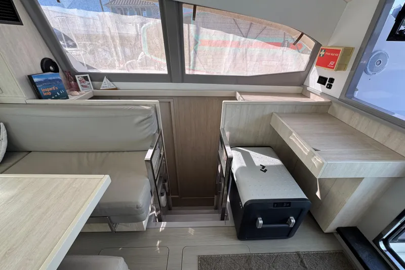 Daylight Yacht Photos Pics Interior of 2018 Leopard 40 catamaran with seating, table, and first aid kit.