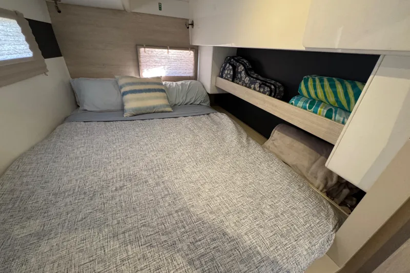 Daylight Yacht Photos Pics Cozy bedroom in 2018 Leopard 40 catamaran with neatly arranged bedding and storage shelves.