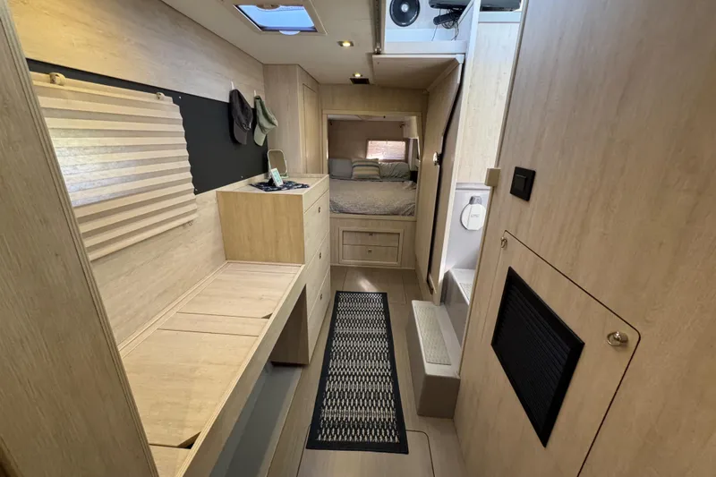 Daylight Yacht Photos Pics Interior of 2018 Leopard 40 catamaran, featuring modern wood finishes and cozy sleeping area.