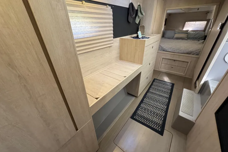 Daylight Yacht Photos Pics Interior of 2018 Leopard 40 catamaran with wooden cabinetry and cozy bedroom.