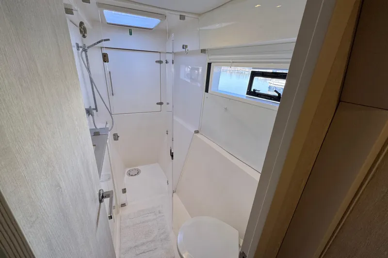 Daylight Yacht Photos Pics Modern bathroom interior on 2018 Leopard 40 yacht with shower and window view.