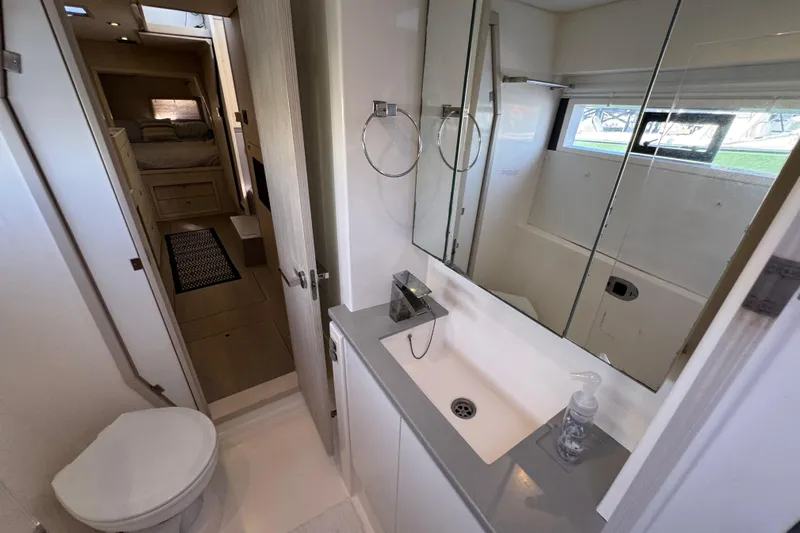 Daylight Yacht Photos Pics Modern bathroom interior on 2018 Leopard 40 catamaran, featuring sink, mirror, and toilet.