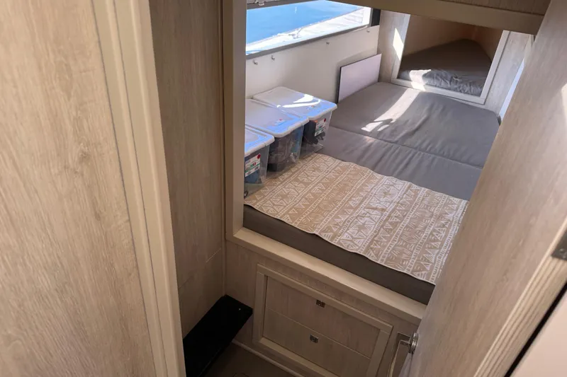 Daylight Yacht Photos Pics Interior cabin of 2018 Leopard 40 catamaran with bed and storage containers.