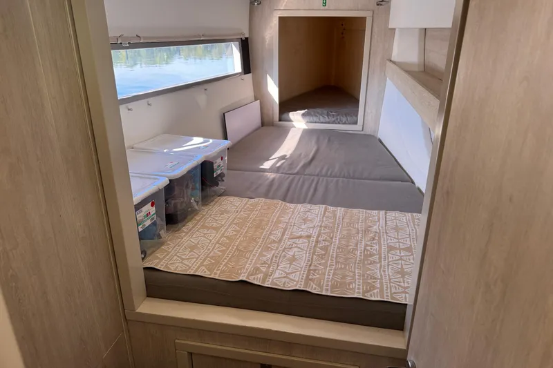 Daylight Yacht Photos Pics 2018 Leopard 40 interior cabin with storage bins and patterned bedding.
