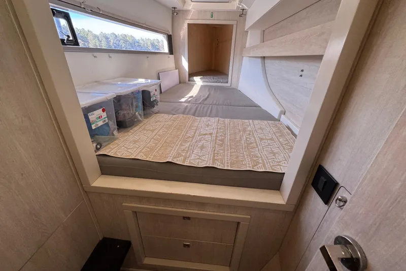Daylight Yacht Photos Pics Interior of 2018 Leopard 40 catamaran cabin with storage and bedding.