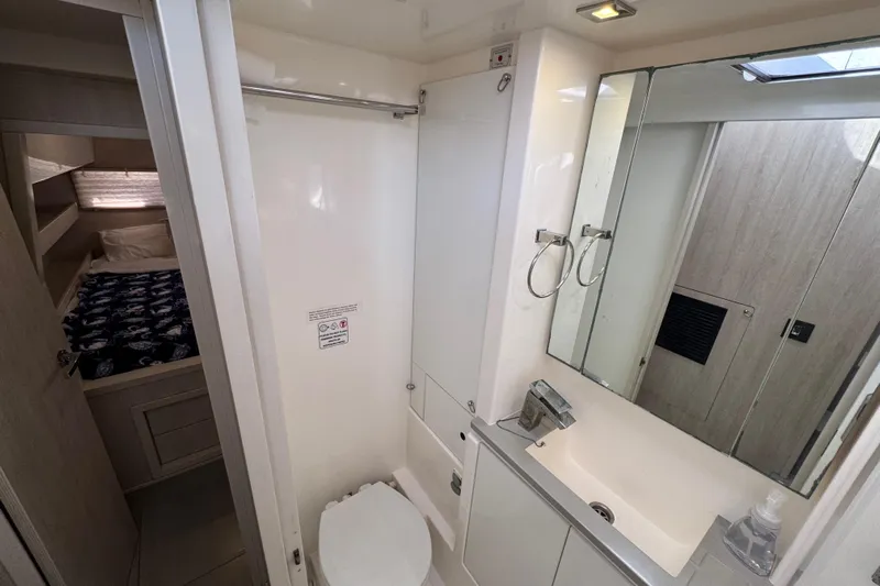 Daylight Yacht Photos Pics Bathroom interior of 2018 Leopard 40 catamaran with modern fixtures and adjacent bedroom.