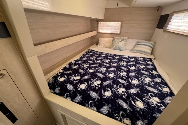 Daylight Yacht Photos Pics Cozy bedroom in 2018 Leopard 40 catamaran with nautical-themed bedding and soft lighting.