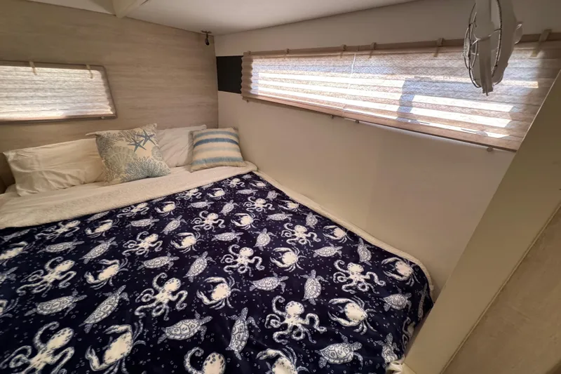 Daylight Yacht Photos Pics Cozy bedroom in 2018 Leopard 40 yacht with nautical-themed bedding and soft lighting.