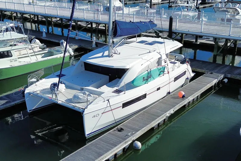 Daylight Yacht Photos Pics 2018 Leopard 40 catamaran docked at marina, featuring sleek design and spacious deck.