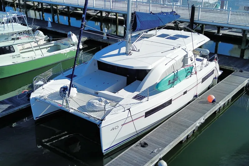 Daylight Yacht Photos Pics 2018 Leopard 40 catamaran docked at marina, featuring sleek design and spacious deck.