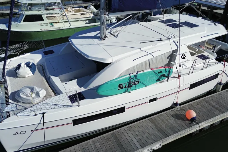 Daylight Yacht Photos Pics 2018 Leopard 40 catamaran docked with paddleboard on deck, featuring spacious layout.