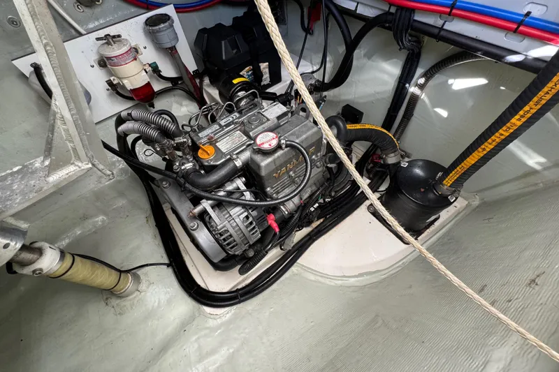 Daylight Yacht Photos Pics Engine compartment of a 2018 Leopard 40 catamaran, showcasing mechanical components and wiring.