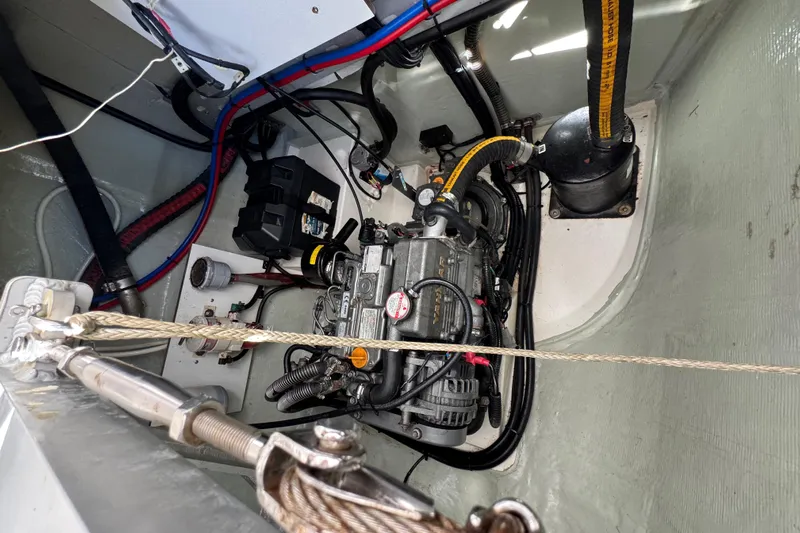 Daylight Yacht Photos Pics Engine compartment of a 2018 Leopard 40 catamaran, showcasing mechanical components and wiring.