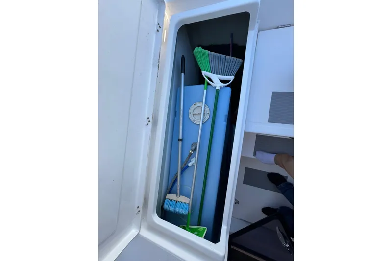 Daylight Yacht Photos Pics Storage compartment on a 2018 Leopard 40 yacht with cleaning tools and equipment.