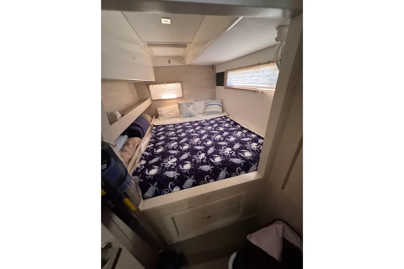 Daylight Yacht Photos Pics Cozy bedroom in 2018 Leopard 40 yacht with nautical-themed bedding and soft lighting.