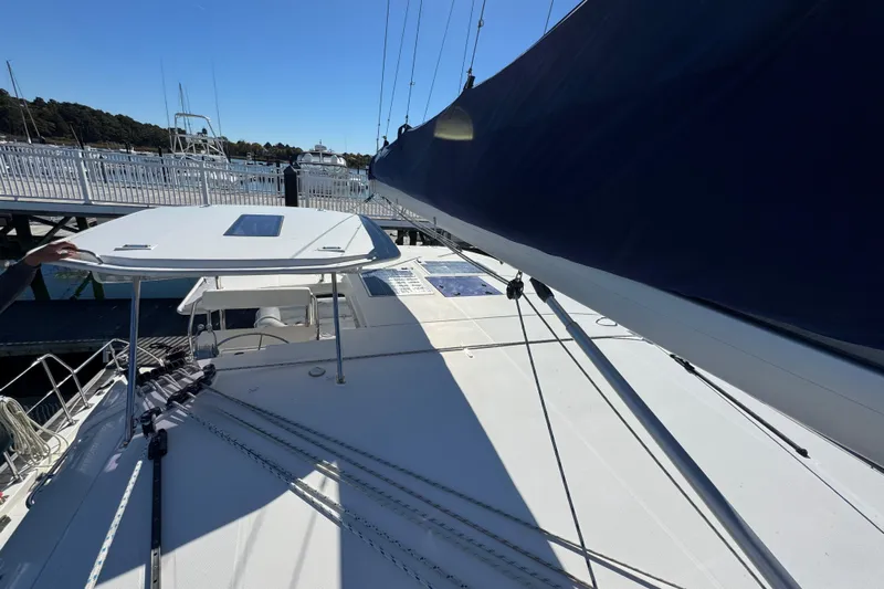 Daylight Yacht Photos Pics 2018 Leopard 40 catamaran deck with sail and marina view.