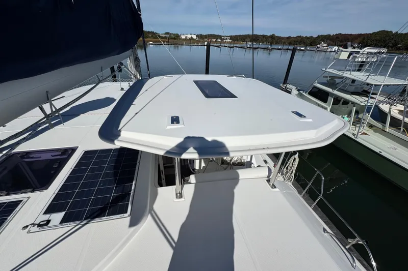 Daylight Yacht Photos Pics 2018 Leopard 40 catamaran with solar panels docked in a serene marina.