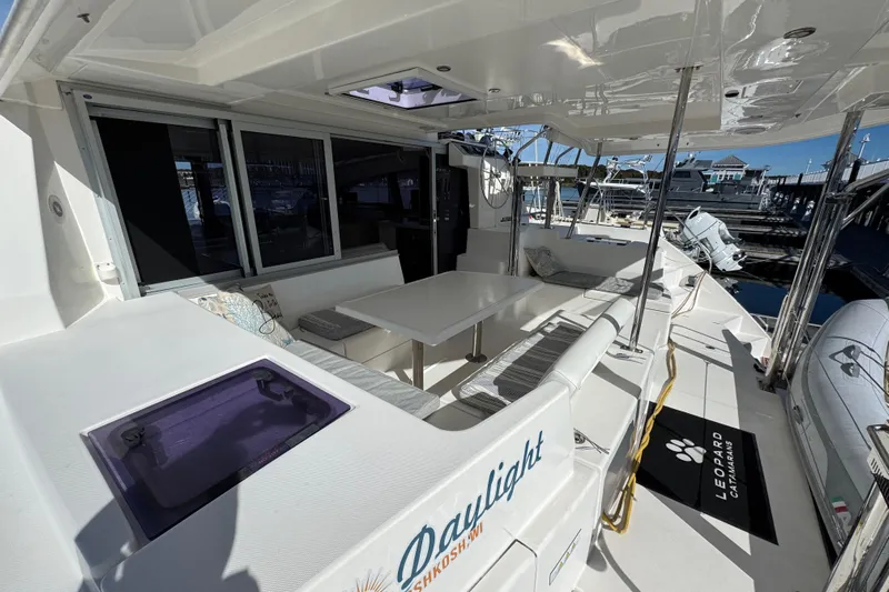 Daylight Yacht Photos Pics 2018 Leopard 40 catamaran deck with seating area and marina view.