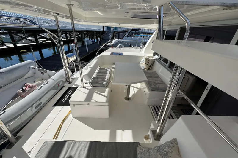 Daylight Yacht Photos Pics 2018 Leopard 40 yacht interior with seating and table, docked at marina.
