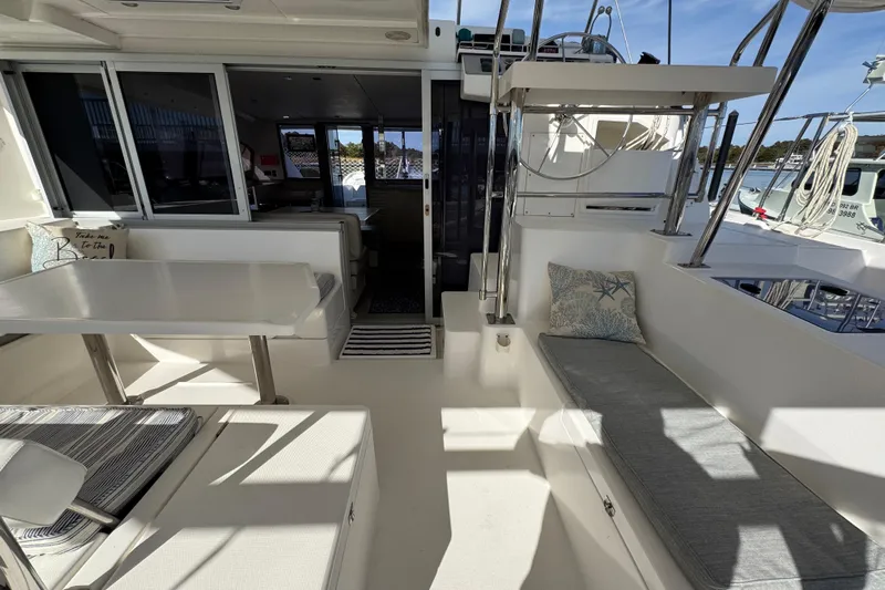 Daylight Yacht Photos Pics 2018 Leopard 40 catamaran interior with seating, table, and helm station.