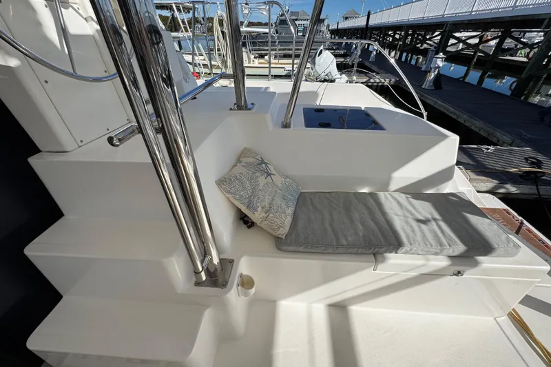 Daylight Yacht Photos Pics 2018 Leopard 40 yacht deck with cushioned seating and stainless steel railings.