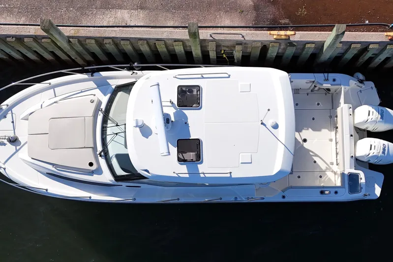  Yacht Photos Pics Overhead view of 2023 Boston Whaler 325 Conquest docked, showcasing sleek design and twin engines.