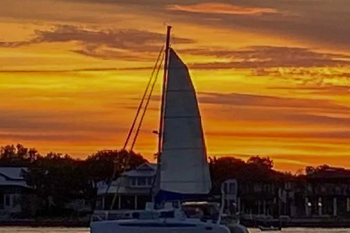 Miss Roxy Yacht Photos Pics Sailboat Dolphin 460 at sunset with vibrant orange sky, 2006 model.