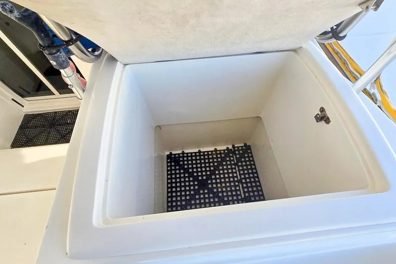 Miss Roxy Yacht Photos Pics Open storage compartment on a 2006 Dolphin 460 boat, featuring a grid base.