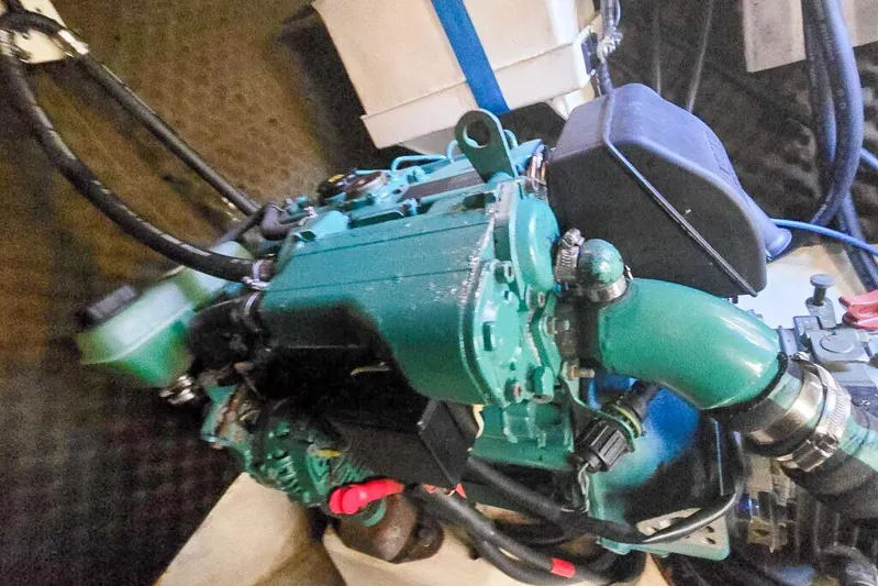 Miss Roxy Yacht Photos Pics Engine of a 2006 Dolphin 460, featuring green components and black hoses.