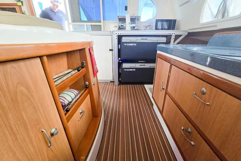 Miss Roxy Yacht Photos Pics Interior of 2006 Dolphin 460 yacht with wooden cabinetry and Dometic appliances.
