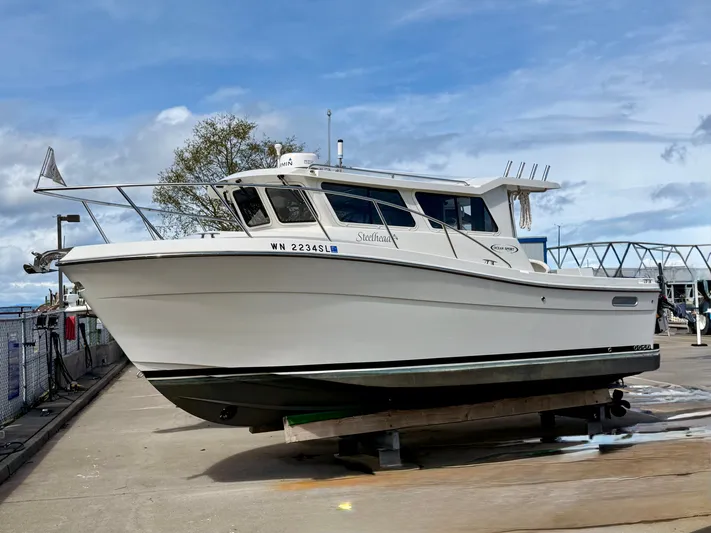  Yacht Photos Pics 2014 Ocean Sport Legacy #4 boat on dry dock under a cloudy sky.