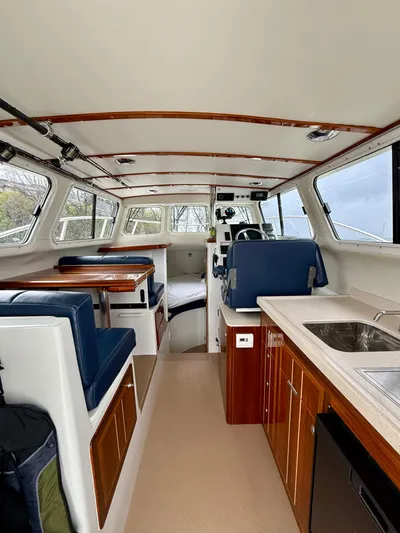  Yacht Photos Pics Interior of 2014 Ocean Sport Legacy #4 boat with seating, kitchenette, and helm.