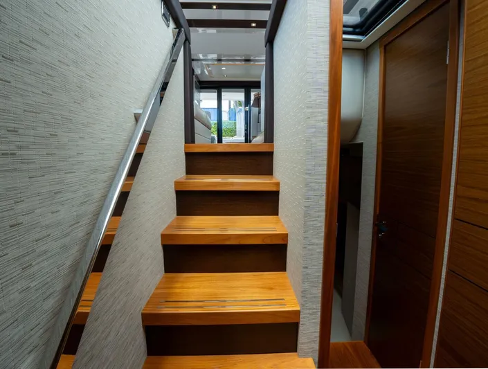 True North Yacht Photos Pics Staircase inside 2017 Tiara Yachts F53 Flybridge, featuring wooden steps and modern design.