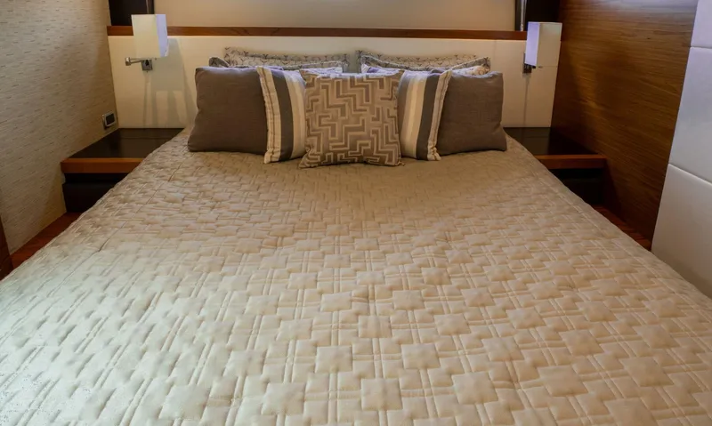 True North Yacht Photos Pics Luxurious bedroom interior of 2017 Tiara Yachts F53 Flybridge with elegant bedding.