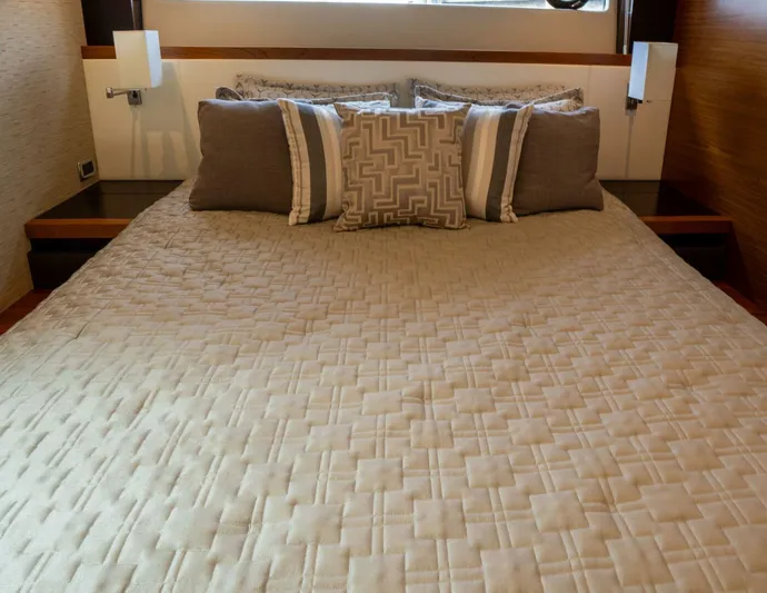 True North Yacht Photos Pics Luxurious bedroom interior of 2017 Tiara Yachts F53 Flybridge with elegant bedding.