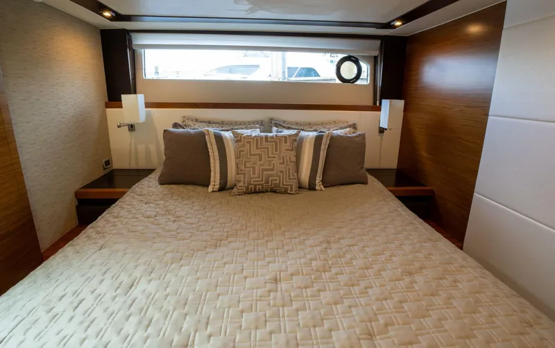 True North Yacht Photos Pics Luxurious bedroom interior of 2017 Tiara Yachts F53 Flybridge with elegant bedding.