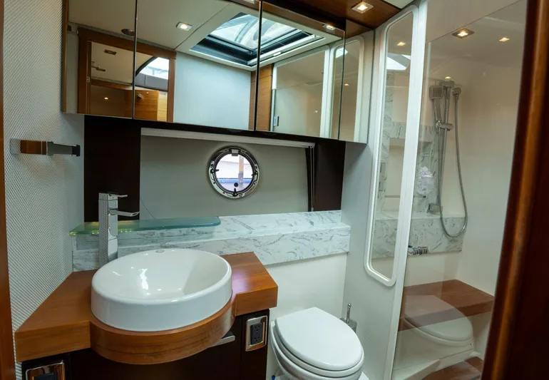 True North Yacht Photos Pics Luxurious bathroom in 2017 Tiara Yachts F53 Flybridge, featuring modern fixtures and elegant design.