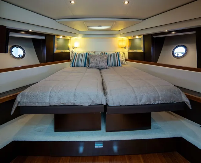 True North Yacht Photos Pics Luxurious 2017 Tiara Yachts F53 Flybridge cabin with elegant bedding and ambient lighting.