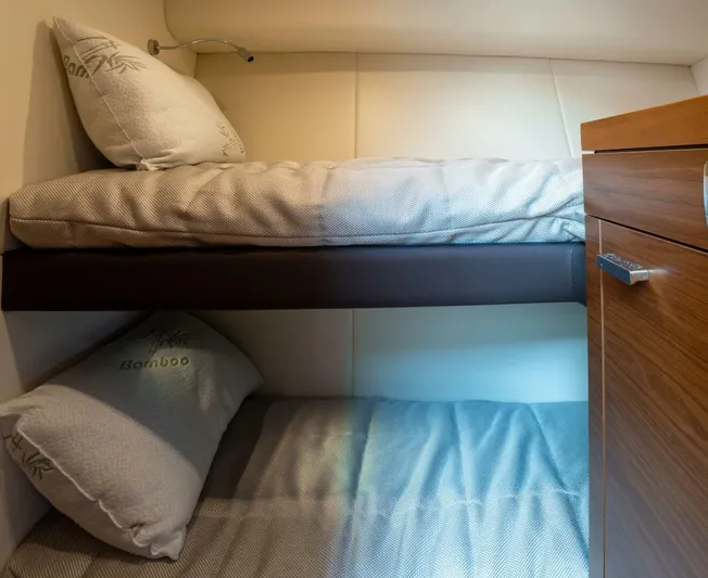 True North Yacht Photos Pics Bunk beds in 2017 Tiara Yachts F53 Flybridge cabin with bamboo pillows.