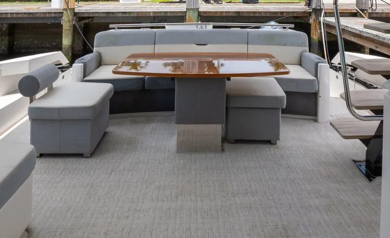 True North Yacht Photos Pics 2017 Tiara Yachts F53 Flybridge interior with elegant seating and wooden table.